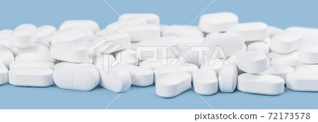 Banner of white tablets or pills on blue table. Medicine and pharmacy Banner of white tablets or pills on blue table. Medicine and pharmacy 72173578