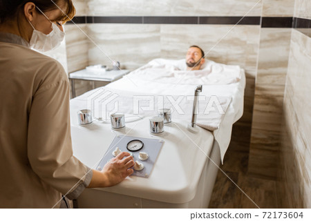 Man with a doctor at balneology room with carbon dioxide bath Man with a doctor at balneology room with carbon dioxide bath 72173604
