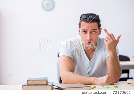 Young male student preparing for exam in the classroom 72173605