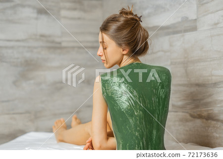 Woman during mud treatment at spa Woman during mud treatment at spa 72173636