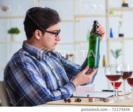 Professional sommelier tasting red wine Professional sommelier tasting red wine 72174849