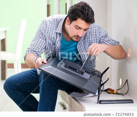 Young man husband repairing tv at home Young man husband repairing tv at home 72174853