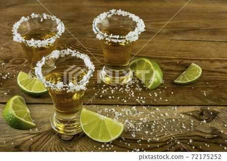 Gold Mexican tequila with lime and salt 72175252