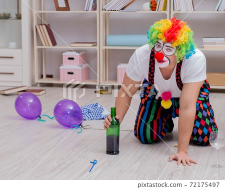 Drunk clown celebrating having a party at home 72175497