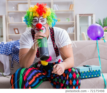 Drunk clown celebrating having a party at home 72175498