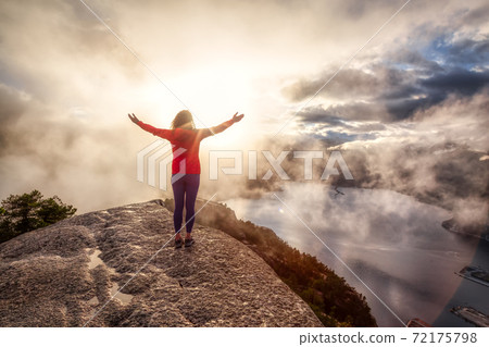 Adventurous Girl Hiking on top of a Peak 72175798