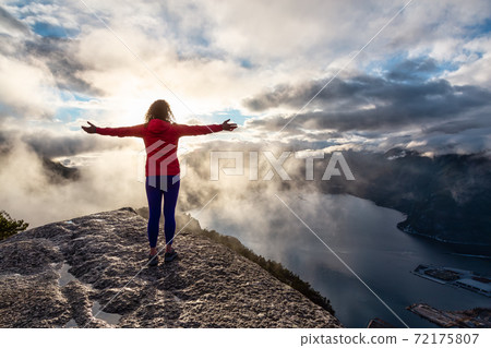 Adventurous Girl Hiking on top of a Peak Adventurous Girl Hiking on top of a Peak 72175807