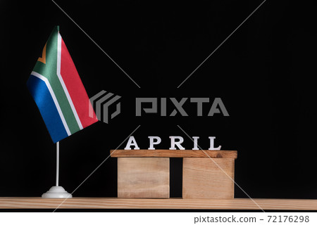 Wooden calendar of April with RSA flag on black background. Dates of South Africa in April . 72176298