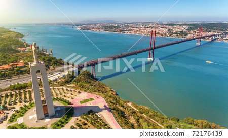 Aerial bridge on April 25th, across the Tejo River, statue of Jesus Christ Lisbon, Portugal. The longest bridge in Europe. Close-up. 72176439