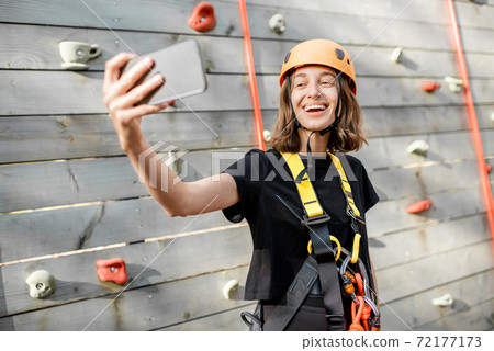 Sports woman taking selfie photo near the climbing wall Sports woman taking selfie photo near the climbing wall 72177173