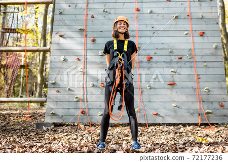 Well equipped woman near the climbing wall 72177236