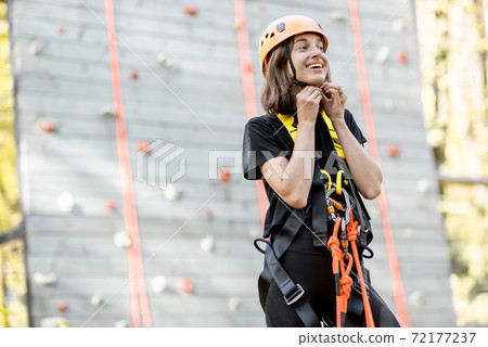Well equipped woman near the climbing wall Well equipped woman near the climbing wall 72177237