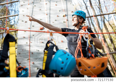 Well equipped man near the climbing wall outdoors 72177530