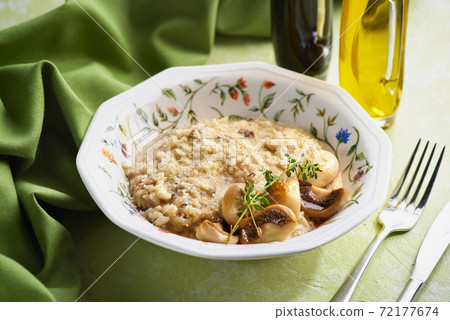 Bowl of Mushroom Risotto garnished with Thyme leaves, selective focus 72177674