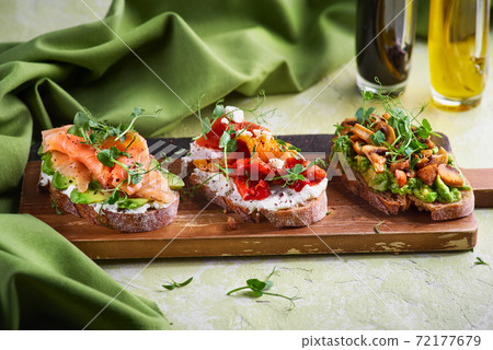 Selection of tasty bruschetta or canapes on taosted baguette and quark cheese topped with smoked salmon, olives, tomato and chorizo sausage Selection of tasty bruschetta or canapes on taosted baguette and quark cheese topped with smoked salmon, olives, tomato and chorizo sausage 72177679