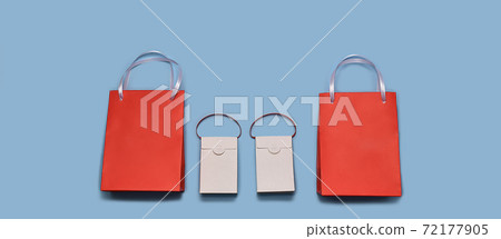 Paper shopping bags lined up in a horizontal row at the bottom. Two reds around the edges and two whites in the center. Paper shopping bags lined up in a horizontal row at the bottom. Two reds around the edges and two whites in the center. 72177905