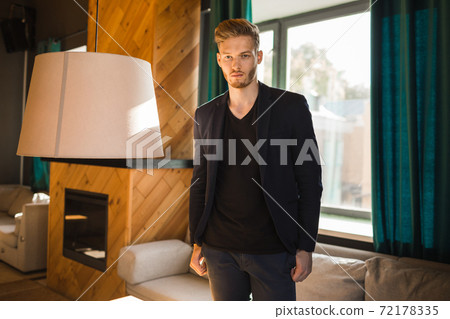 successful beautiful young man blond is located in a modern loft room, hookah successful beautiful young man blond is located in a modern loft room, hookah 72178335