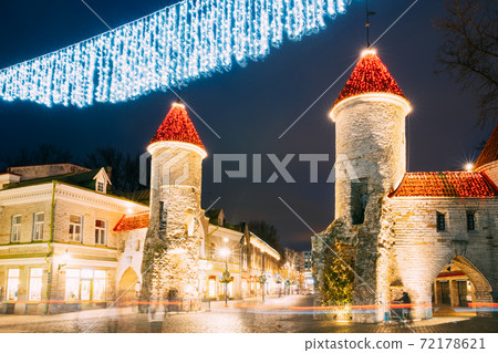 Tallinn, Estonia. Famous Landmark Viru Gate In Street Lighting At Evening Or Night Illumination. Towers In Christmas Holidays Decorations Tallinn, Estonia. Famous Landmark Viru Gate In Street Lighting At Evening Or Night Illumination. Towers In Christmas Holidays Decorations 72178621