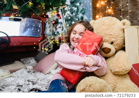 Happy girl hold red Christmas gift box 72179253