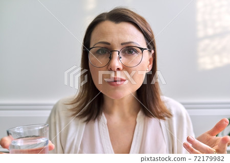 Female psychologist, psychiatrist looking at webcam, closeup face Female psychologist, psychiatrist looking at webcam, closeup face 72179982
