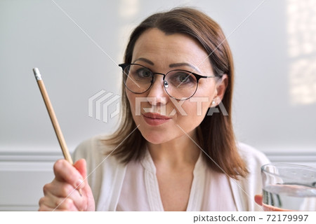 Female mentor, tutor, teacher looking at webcam, closeup face Female mentor, tutor, teacher looking at webcam, closeup face 72179997