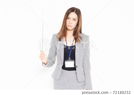 An angry-faced young businesswoman with a pointer An angry-faced young businesswoman with a pointer 72180252