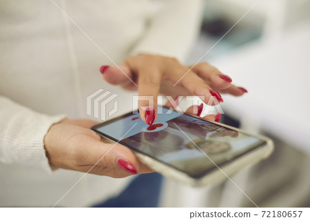 Hands of young female choosing boyfriend or possible husband in online dating application 72180657