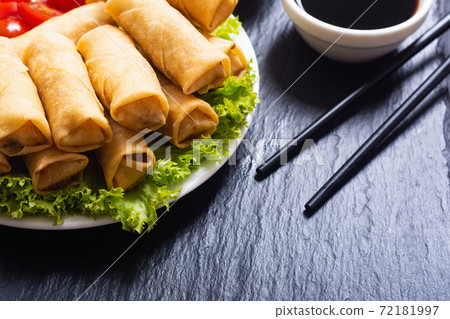 Fried spring rolls with vegetables on rustic background Fried spring rolls with vegetables on rustic background 72181997