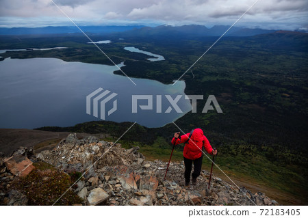 Girl Hiking on top of a Mountain Peak Girl Hiking on top of a Mountain Peak 72183405