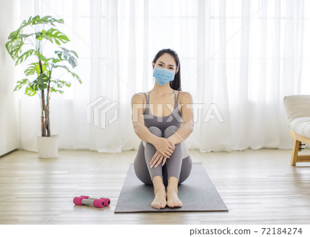 Fitness woman streching Relaxing after training and wearing  protectve face mask during Covid 19 72184274