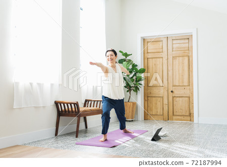Middle woman doing yoga at home 72187994