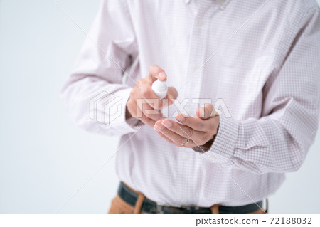 Senior man disinfecting with alcohol spray Senior man disinfecting with alcohol spray 72188032