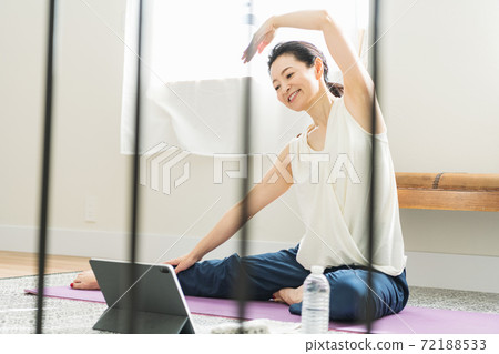 Middle woman stretching at home Middle woman stretching at home 72188533