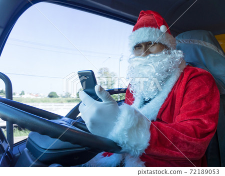 Truck driver wearing Santa Claus on Christmas Truck driver wearing Santa Claus on Christmas 72189053
