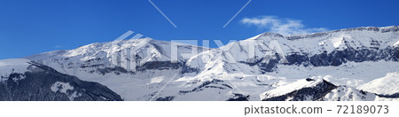 Panorama of winter snowy mountains at sunny day 72189073