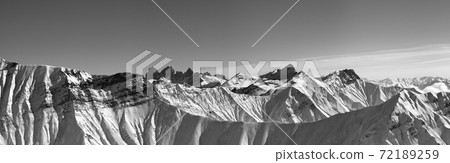 Large panorama of snowy mountains in sun winter evening 72189259