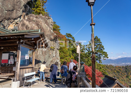 A person looking at Meotoiwa from the observation deck of Tarobomiya, Higashiomi City, Shiga Prefecture A person looking at Meotoiwa from the observation deck of Tarobomiya, Higashiomi City, Shiga Prefecture 72190038