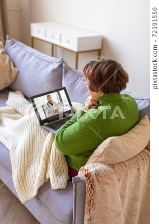Sick senior woman at home during online cousultation with a doctor. Verticacl photo. Sick senior woman at home during online cousultation with a doctor. Verticacl photo. 72191550