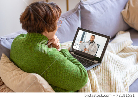 Photo of a sick senior woman at home during online cousultation with a doctor. Photo of a sick senior woman at home during online cousultation with a doctor. 72191551