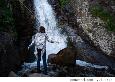Young happy woman enjoing the summer waterfall. Young happy woman enjoing the summer waterfall. 72192548