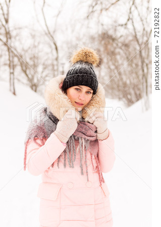 Young girl in a snowy forest in winter. 72192822