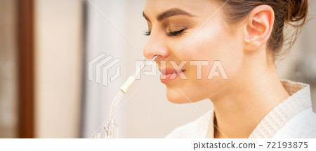 Woman receiving essential oil inhaler 72193875