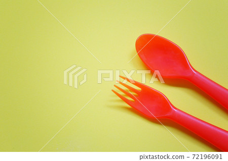 Plastic spoon and fork placed on a bright background. Plastic spoon and fork placed on a bright background. 72196091