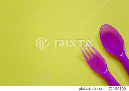 Plastic spoon and fork placed on a bright background. Plastic spoon and fork placed on a bright background. 72196100