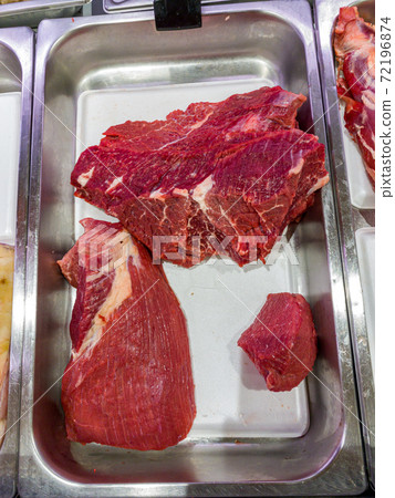 Vertical photo of fresh beef meat at butcher shop 72196874