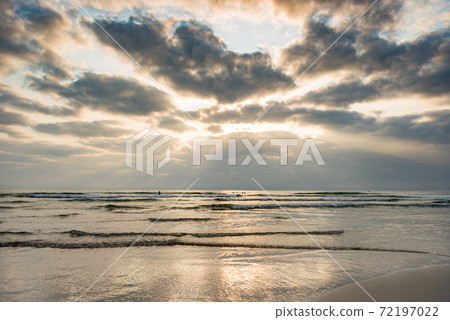 Cloudy sky on tranquil beach at sunset evening 72197022