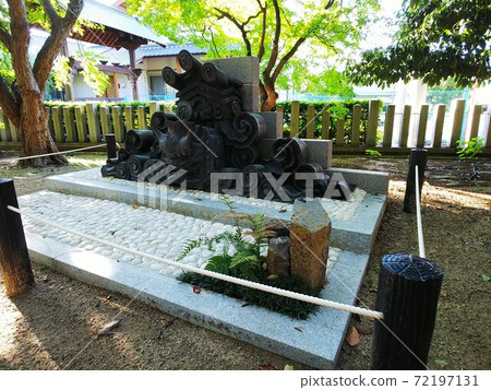 An old onigawara exhibited and preserved in the precincts of a fresh green shrine 72197131