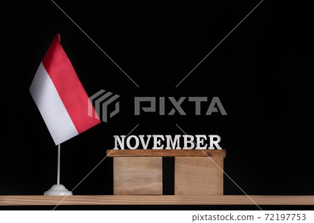 Wooden calendar of November with Polish flag on black background. Holidays of Poland in November . Wooden calendar of November with Polish flag on black background. Holidays of Poland in November . 72197753