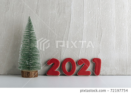 Small artificial Christmas tree and red numbers 2021. New year concept. Copy space Small artificial Christmas tree and red numbers 2021. New year concept. Copy space 72197754