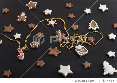 Set ginger biscuits glazed sugar icing. Stars, gingerbread man, fir-tree from gingerbread on black background 72197757
